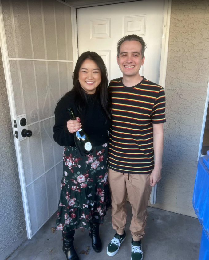 Aaron Martinez and his wife in front of their new home